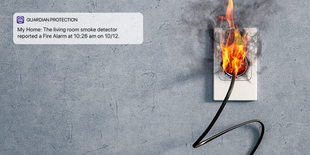 Outlet with plug on fire and Guardian Protection app notification of fire alarm