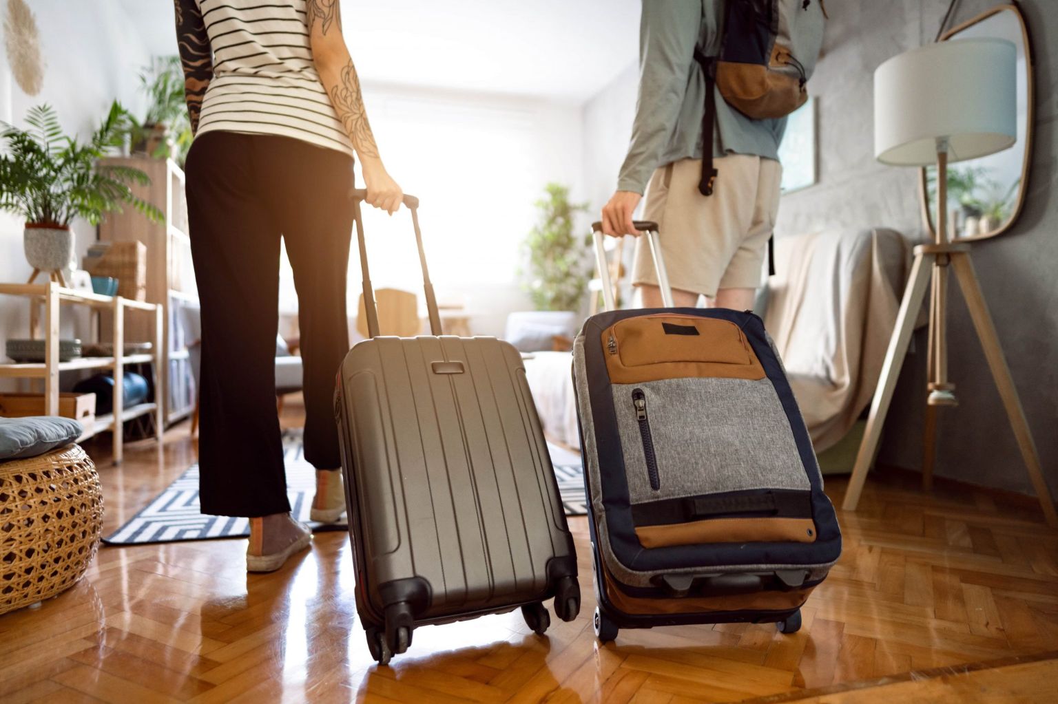 Couple with suitcases visiting their Airbnb