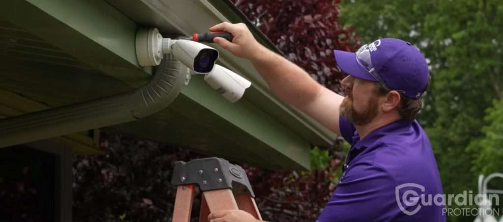 Guardian Protection technician installing security camera at Animal Friends
