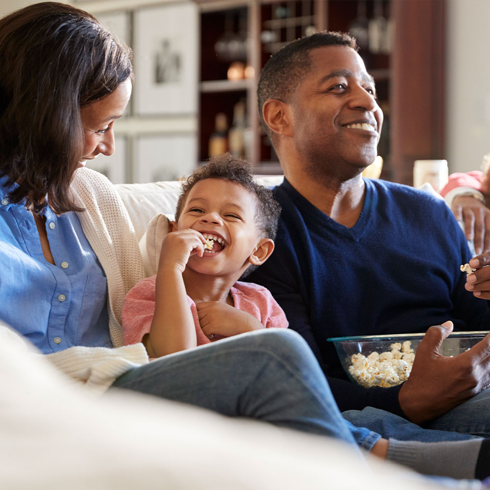 A family watching TV with their home entertainment system
