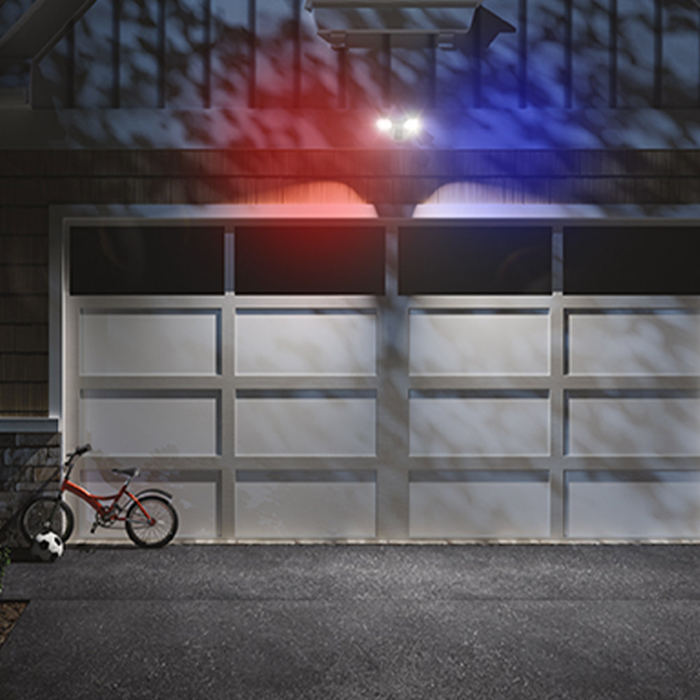 Guardian Protection floodlight security camera installed above a home's garage door