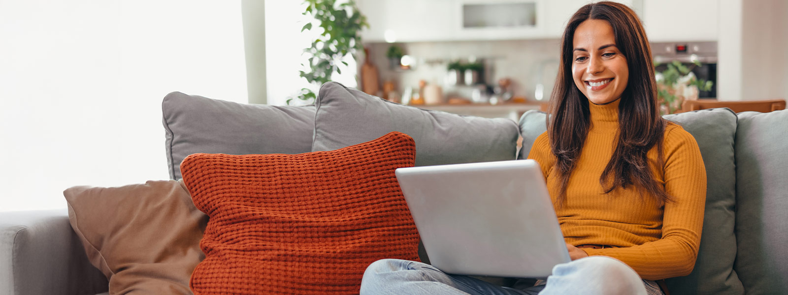 Woman using laptop that utilizes Guardian Protection's smart connections