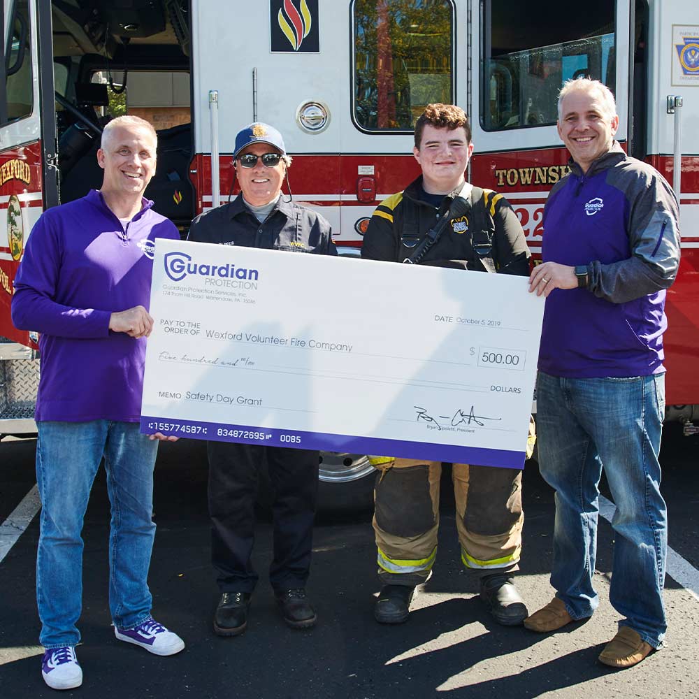 Guardian Protection employees donating to local fire department