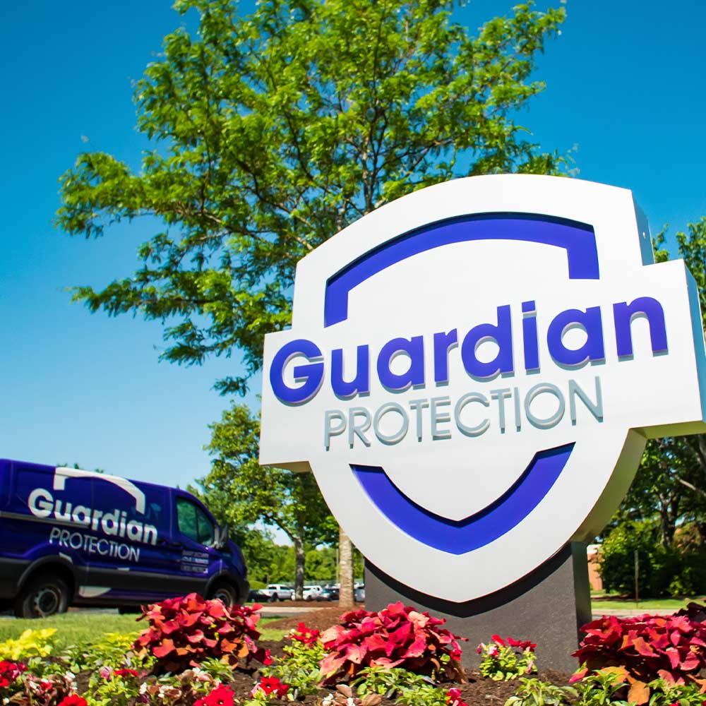 Guardian Protection HQ sign and purple van