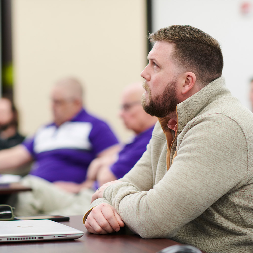 A man sitting in a meeting
