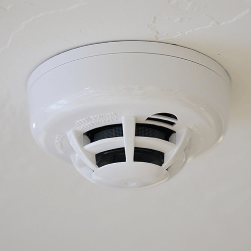 Guardian Protection smoke and heat detector mounted on a ceiling 