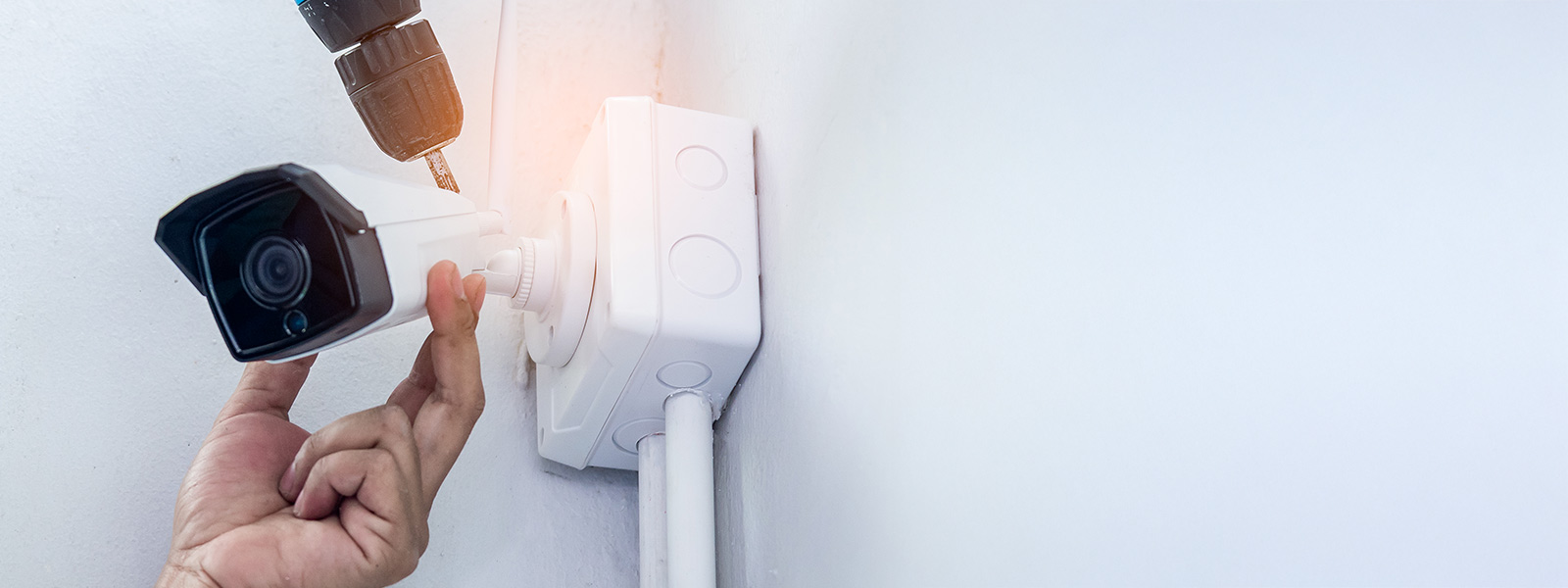 A Guardian Protection technician installing an outdoor camera