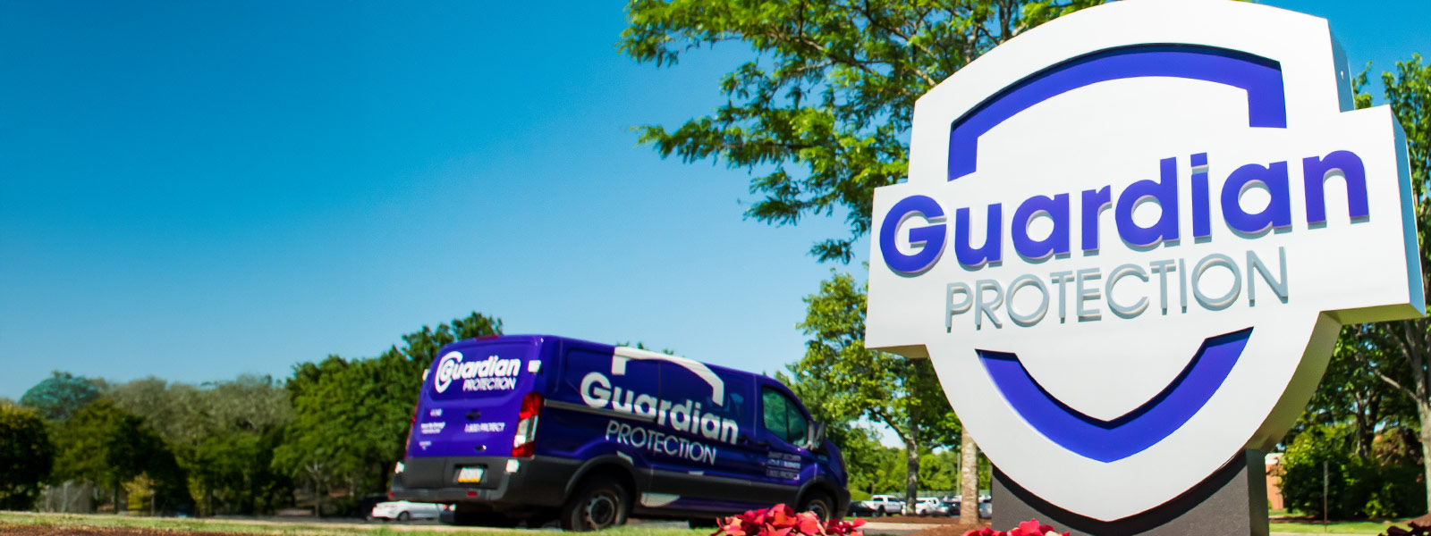 Sign at Guardian Protection headquarters with technician van