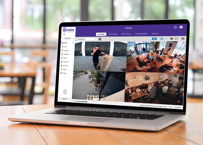 Laptop opened to four different video surveillance views of property