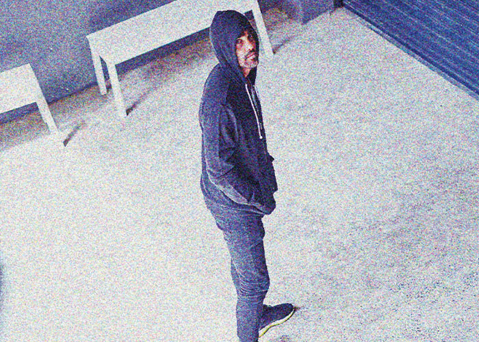 Man wearing a hoodie caught on security surveillance footage