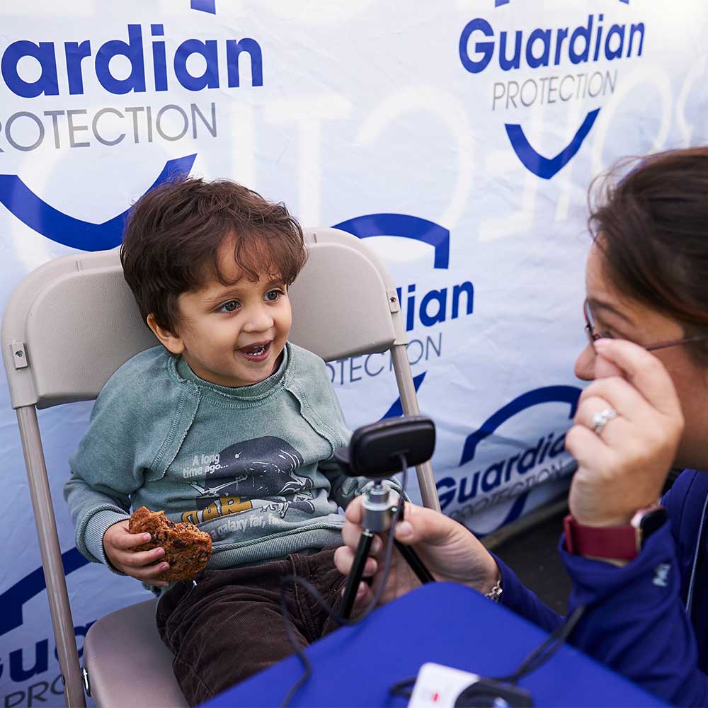 Guardian Protection employee and child at Kids ID event