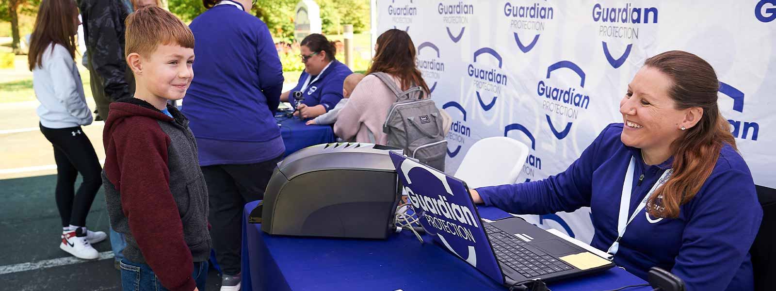 Guardian Protection employee and child at Kids ID event