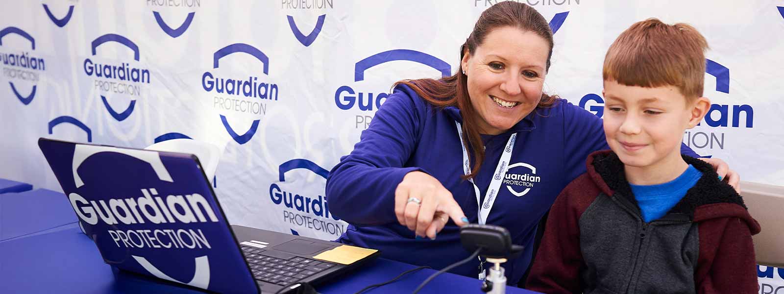 Guardian Protection employee and child at Kids ID event