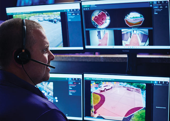 Man viewing proactive video surveillance live camera feeds from Guardian's monitoring center